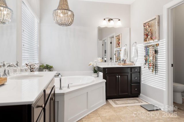 full bath with toilet, an inviting chandelier, a sink, tile patterned flooring, and a bath