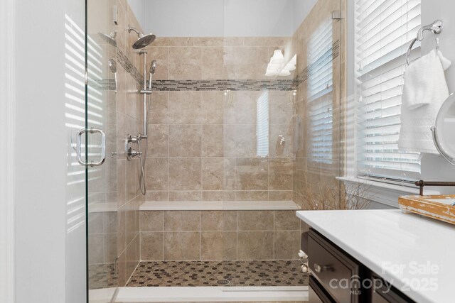 full bathroom featuring a stall shower and vanity