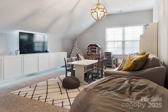 recreation room featuring carpet floors and vaulted ceiling