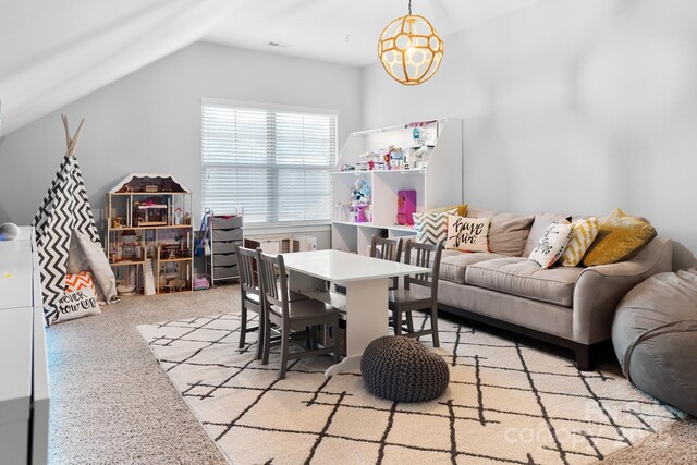 rec room featuring vaulted ceiling, carpet, and a notable chandelier