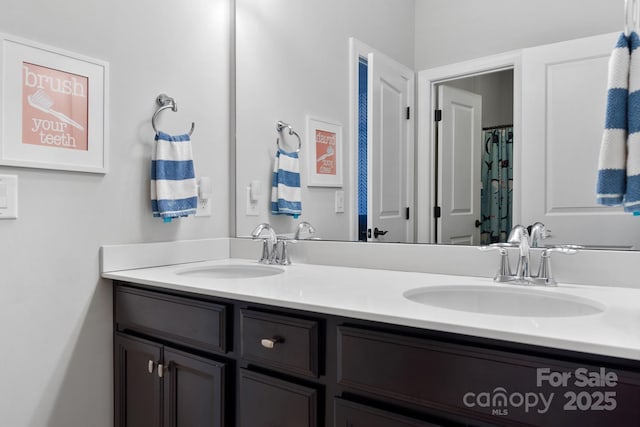 full bath with a sink and double vanity