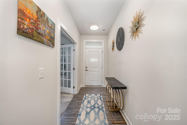 corridor with dark hardwood / wood-style floors