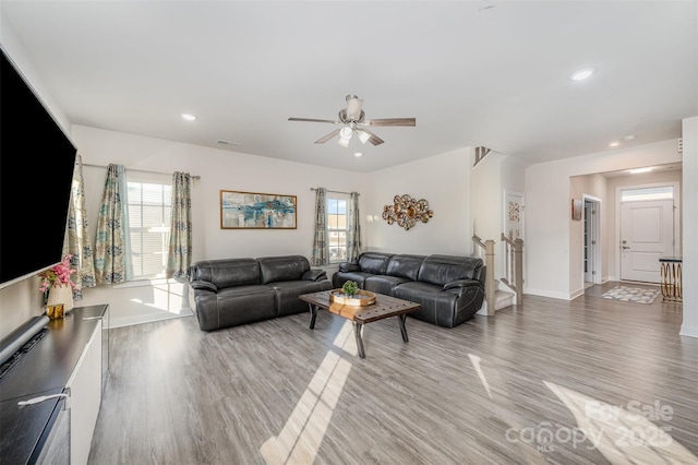 living room featuring hardwood / wood-style flooring, plenty of natural light, and ceiling fan