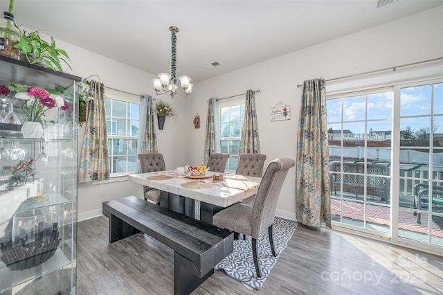 dining room with a notable chandelier and hardwood / wood-style floors