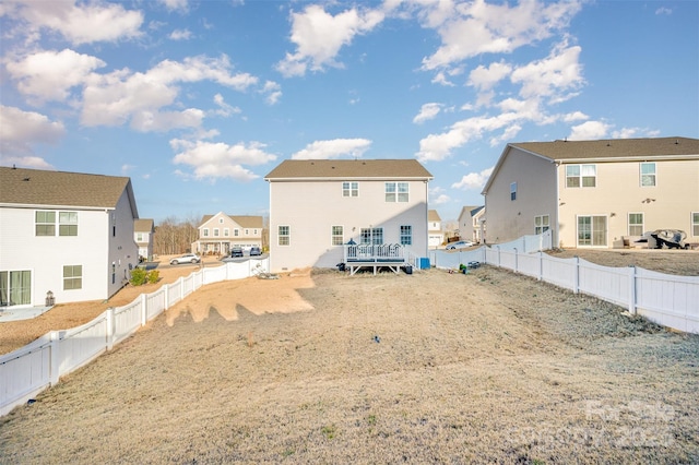 rear view of property featuring a wooden deck