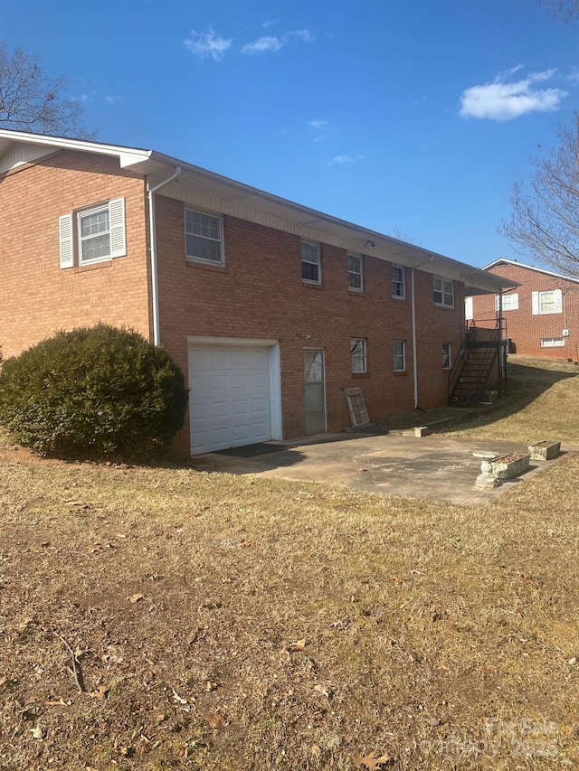 rear view of property with a garage