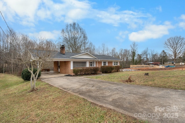 ranch-style home featuring a carport and a front yard