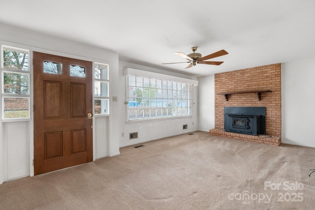 unfurnished living room featuring ceiling fan and light colored carpet