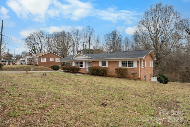 ranch-style home with a front lawn