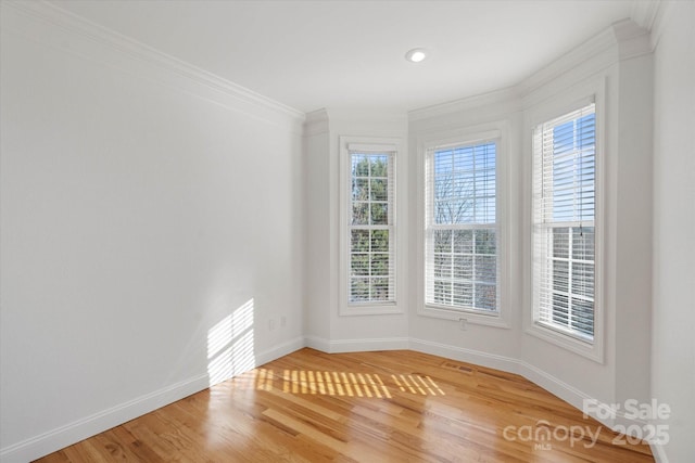 unfurnished room featuring hardwood / wood-style flooring and ornamental molding