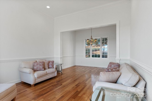 living area featuring crown molding and hardwood / wood-style floors