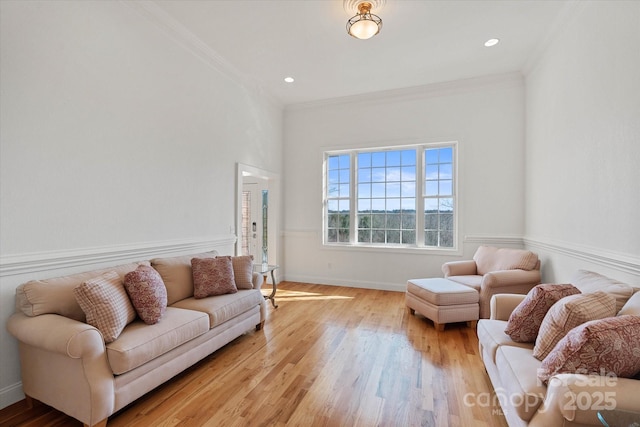 living room with light wood-type flooring and crown molding