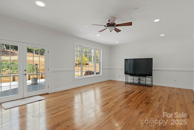 unfurnished living room with ceiling fan, french doors, light wood-type flooring, and ornamental molding