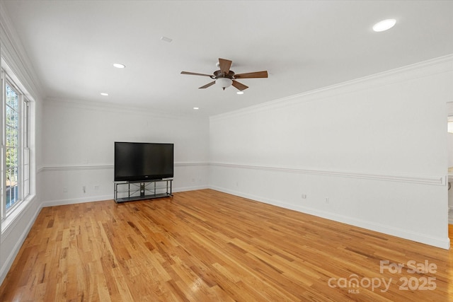 unfurnished living room with ceiling fan, crown molding, and light hardwood / wood-style flooring