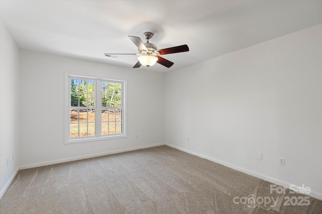 empty room featuring ceiling fan and light carpet