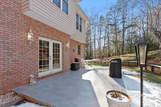 snow covered patio with french doors