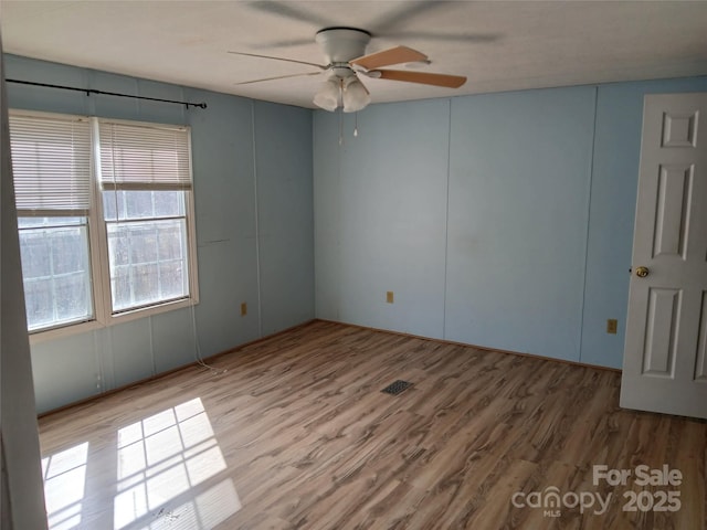 unfurnished room featuring ceiling fan and hardwood / wood-style floors