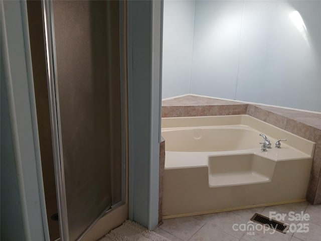 bathroom featuring tile patterned flooring and a bathtub