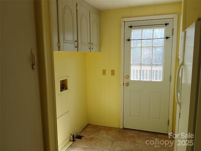 laundry room featuring cabinets, light tile patterned flooring, and washer hookup