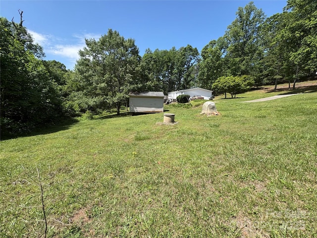 311 Coopers Gap Rd, Rutherfordton, NC 28139 - view of grassy yard with a storage unit and an outbuilding