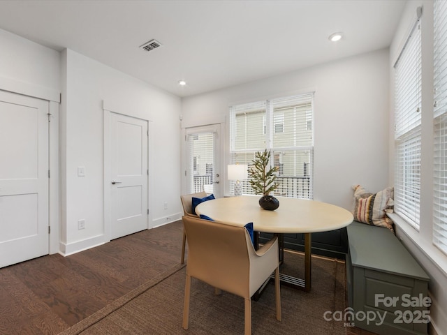 dining space featuring dark wood-type flooring