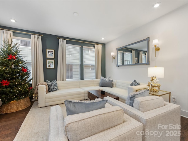 living room with dark hardwood / wood-style flooring and plenty of natural light