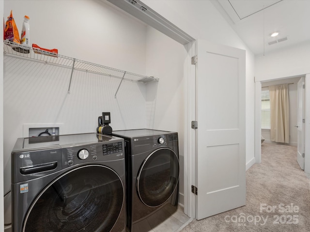 washroom featuring separate washer and dryer and light colored carpet