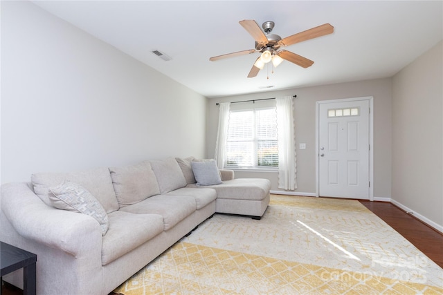 living room featuring ceiling fan and wood-type flooring