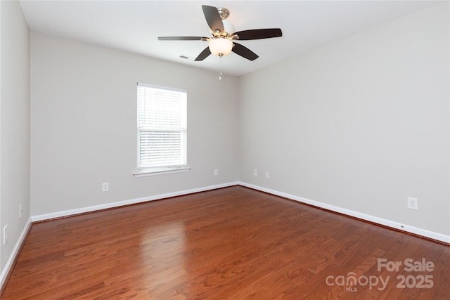 spare room with hardwood / wood-style flooring and ceiling fan