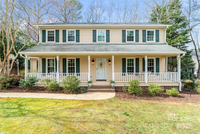 view of front facade featuring a porch, a shingled roof, and a front lawn