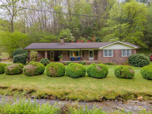 single story home featuring a front lawn, crawl space, brick siding, and covered porch