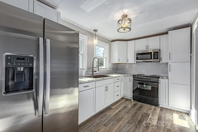 kitchen featuring sink, white cabinets, light stone countertops, dark hardwood / wood-style floors, and appliances with stainless steel finishes