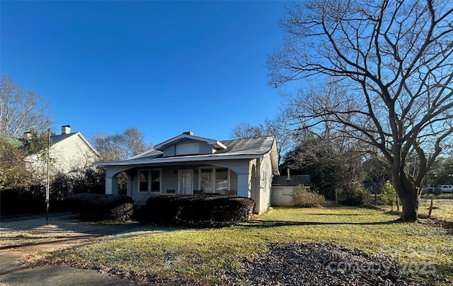 bungalow featuring a porch and a front yard