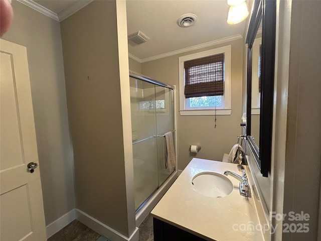 full bath featuring vanity, visible vents, baseboards, ornamental molding, and a shower stall