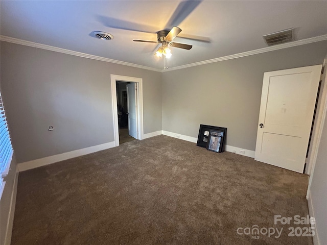 unfurnished bedroom featuring dark carpet, visible vents, crown molding, and baseboards