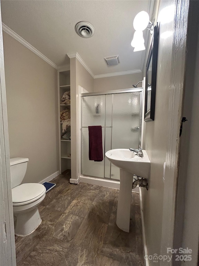 bathroom with toilet, a stall shower, visible vents, and crown molding