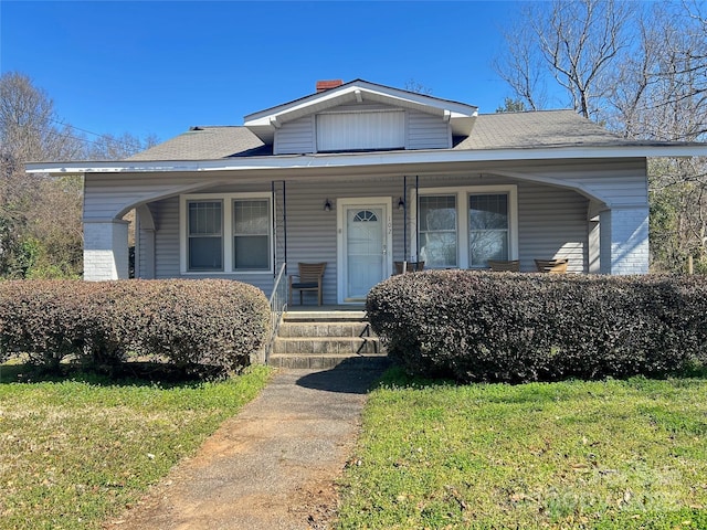 bungalow-style house featuring a porch and a front yard