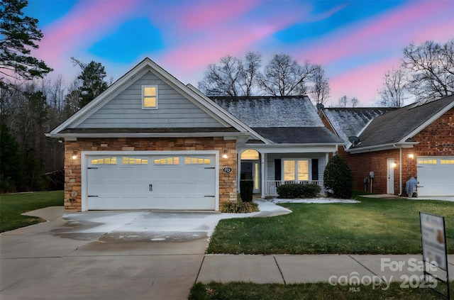 view of front of property featuring a lawn and a garage