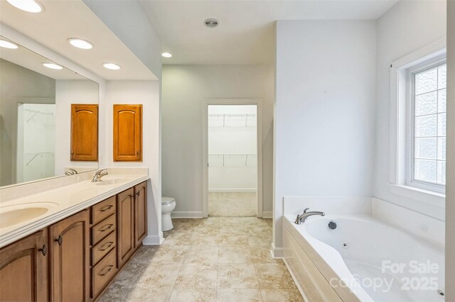 629 Cordova Ct, Salisbury, NC 28146 - bathroom with double vanity, toilet, a jetted tub, recessed lighting, and healthy amount of natural light