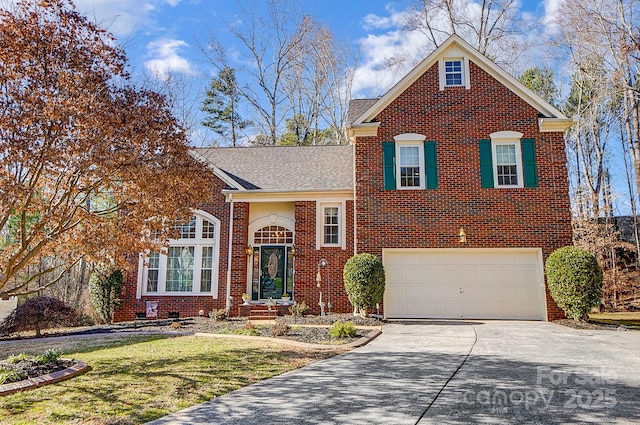 view of property with a garage and a front lawn