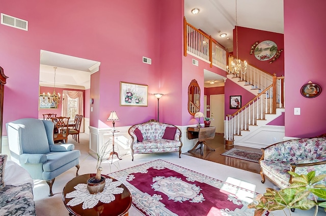 living room featuring a chandelier and high vaulted ceiling