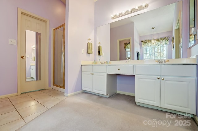 bathroom featuring tile patterned flooring, vanity, an enclosed shower, and an inviting chandelier