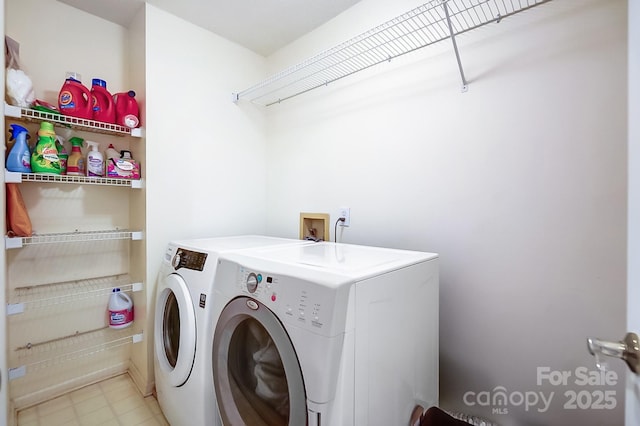 clothes washing area featuring washer and dryer