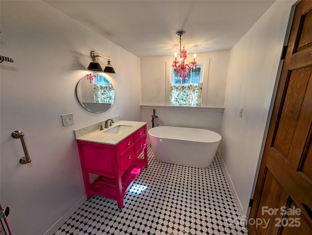 bathroom with a tub to relax in and vanity