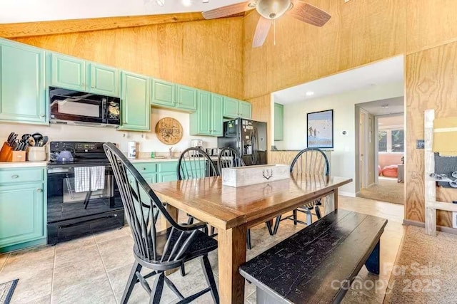 tiled dining area with a towering ceiling and ceiling fan