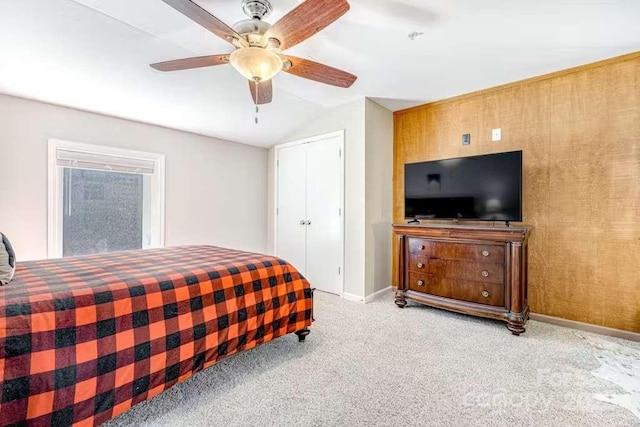 carpeted bedroom with lofted ceiling, ceiling fan, and a closet