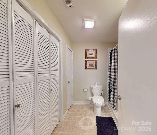 bathroom featuring tile patterned floors and toilet