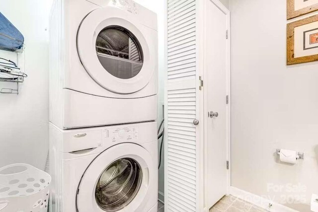 washroom with stacked washer / drying machine