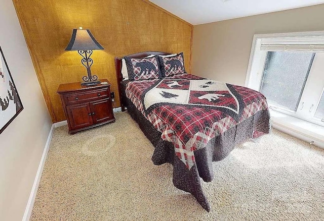 carpeted bedroom featuring vaulted ceiling