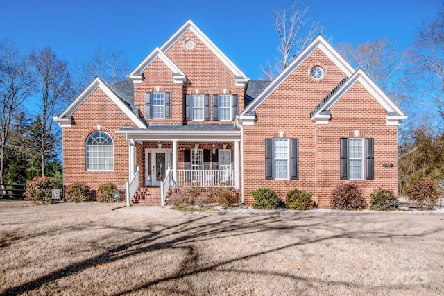 view of front property featuring a front yard and covered porch